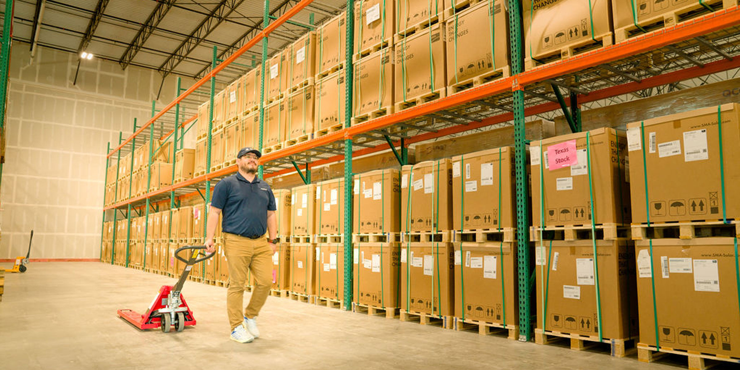 Buda Manufacturing Warehouse with man pulling pallet jack