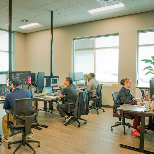 People working on computers in a workspace