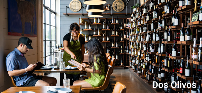 Waitress serving customers at Dos Olivos